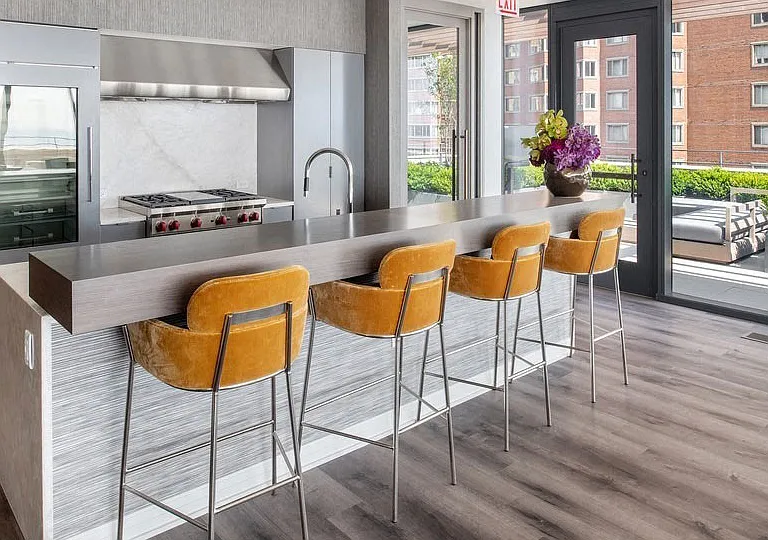 This commercial kitchen with bar and beverage center in the private rooftop club is perfect for hosting an unforgettable evening.