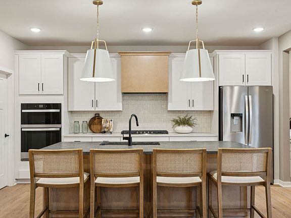 A chef s dream kitchen with sleek appliances, a spacious island, and elegant finishes.