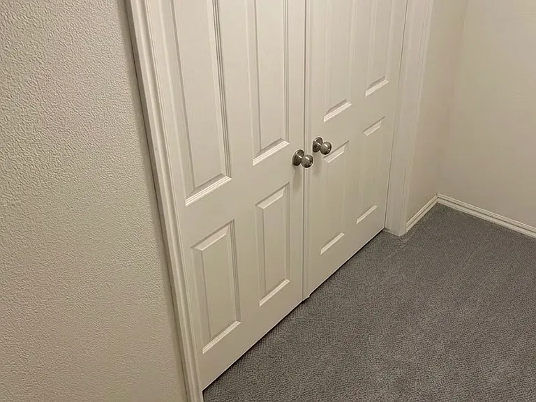 Double doors to large basement room and bathroom