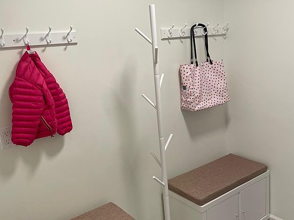 Mud/entry/laundry room has a heated floor and opens from the garage to a half bath and kitchen.