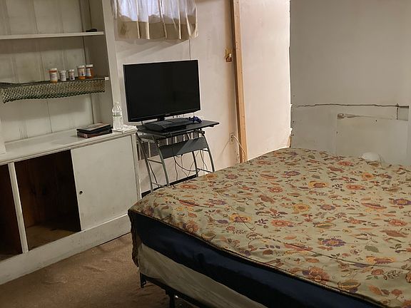 Bedroom with full-size bed in it clothing unit TV, clean comfortable warm winters