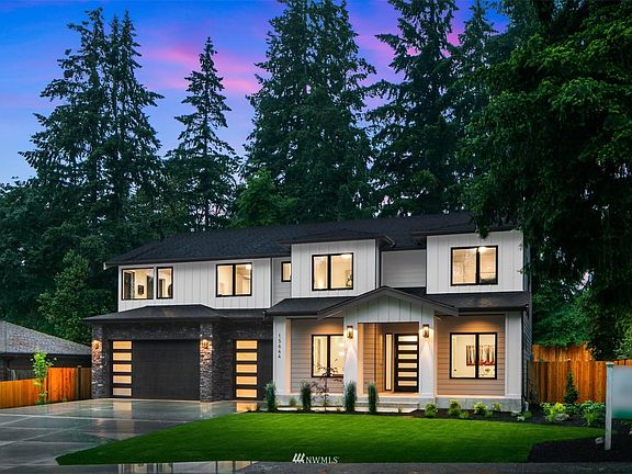 Northwest Contemporary design with extensive stonework, black casement windows, and oversized driveway to provide ample guest parking!