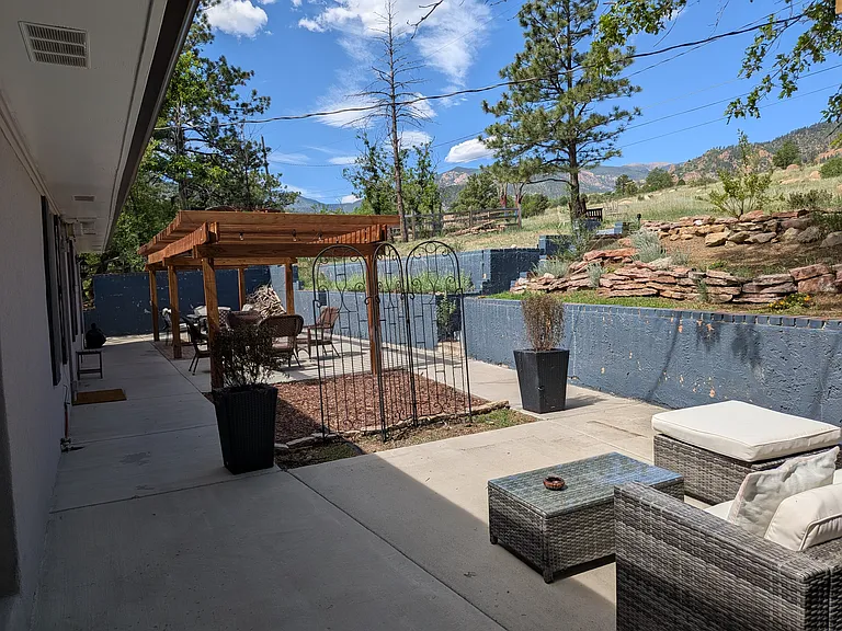 Large patio with trellis and several seating areas is accessible from the Dining Room, the Kitchen and the Master Bedroom