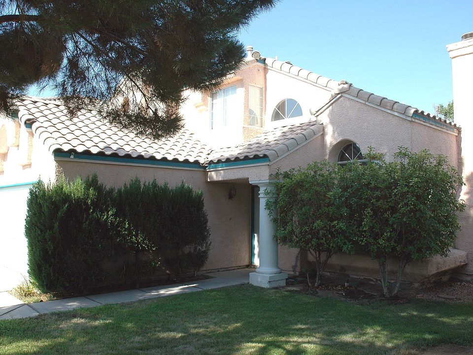 Surrounded by grass and mature plantings