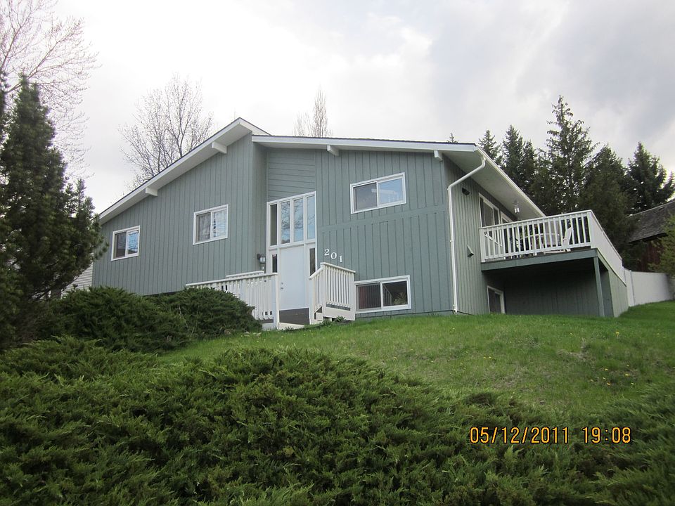 Sidewalk leads to driveway and front porch/door