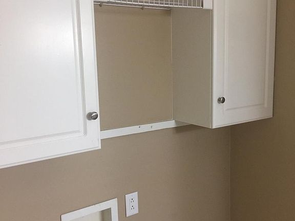 Laundry hook-ups with cabinetry above