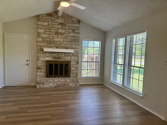 Living room fireplace and exterior door to side and back yard areas.
