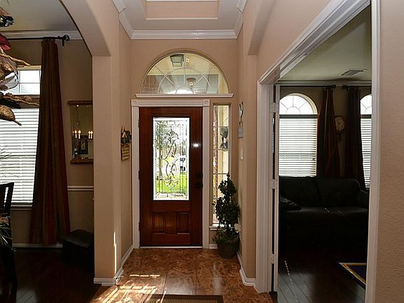 Entry offering a beveled glass front door, Tile floors, Double crown molding and raised ceilings.