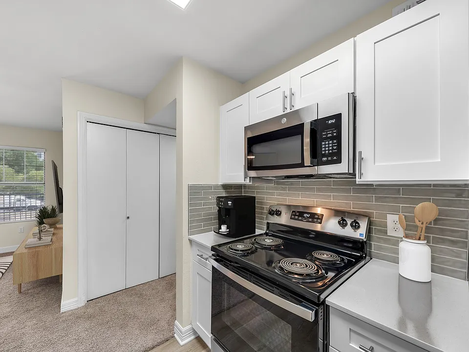 A Deluxe Kitchen with White Shaker Cabinets and Stainless Steel Appliances