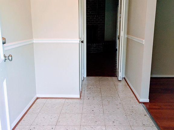Foyer. Front door has storm door as well. Mail box conveniently next to front door. You can also see the coat/shoe closet
