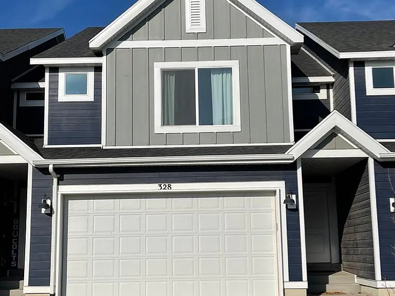 Townhome Exterior with 2 Car Garage and Driveway Parking