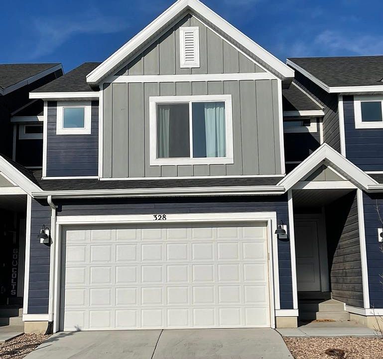 Townhome Exterior with 2 Car Garage and Driveway Parking
