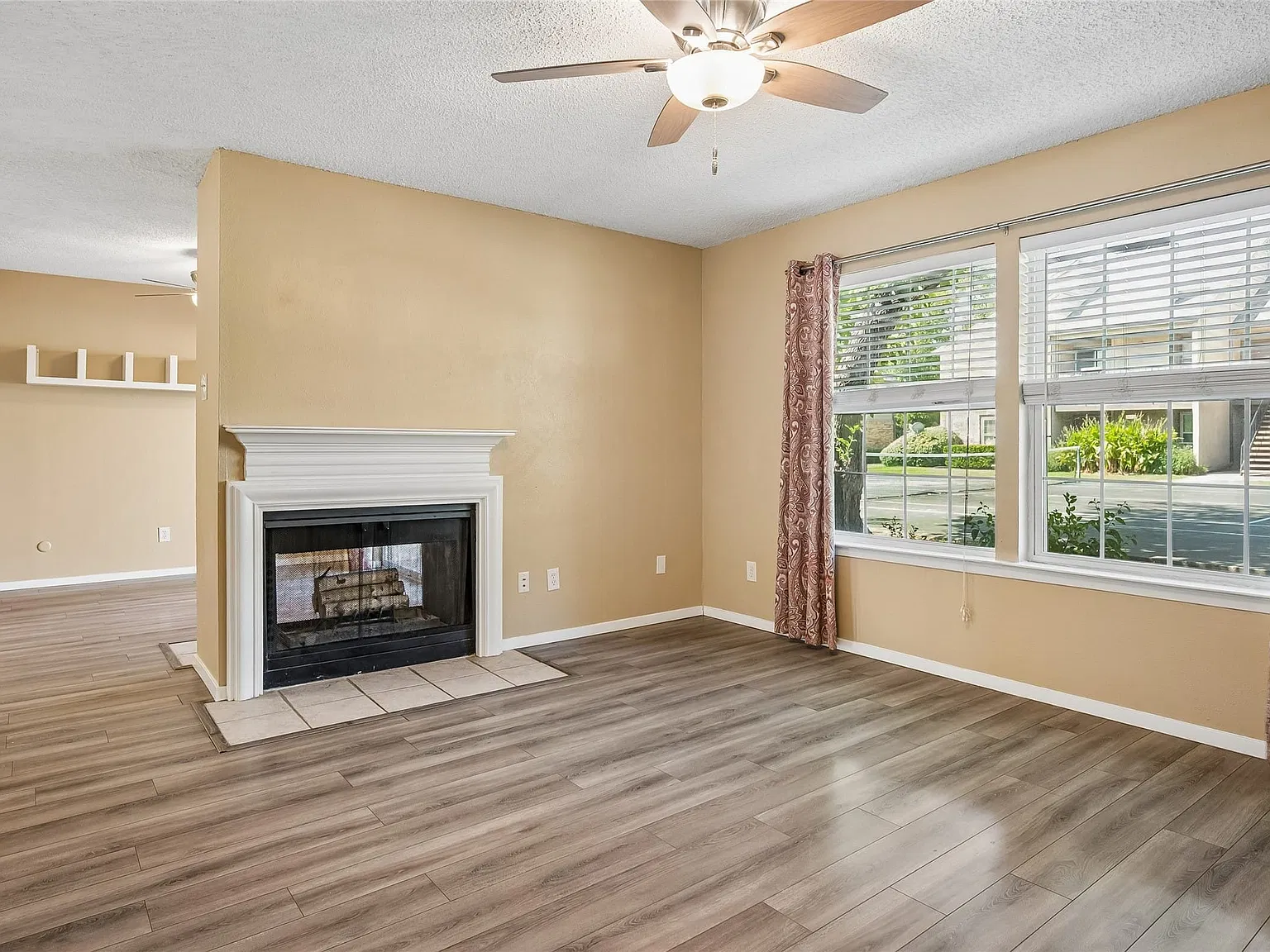 Living room with see through fireplace and ceiling fan