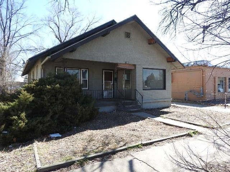Front of the house with a nice front porch and separate entries for upstairs and downstairs.