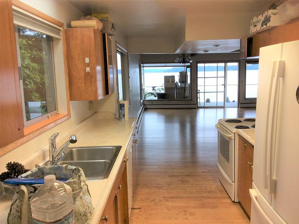 Kitchen view with double sink, dishwasher, refrigerator and stove