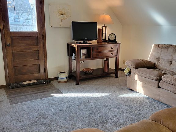 Living Room, showing cabinetry for TV and door to balcony
