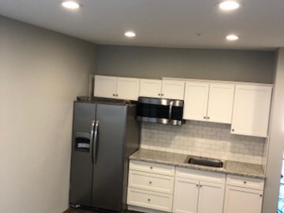 Kitchen has stove, fridge, microwave
