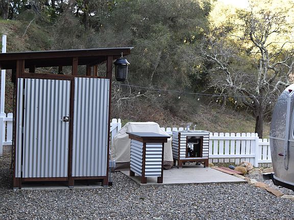 Outside shower, gas grill , preparation table, and outdoor sink.