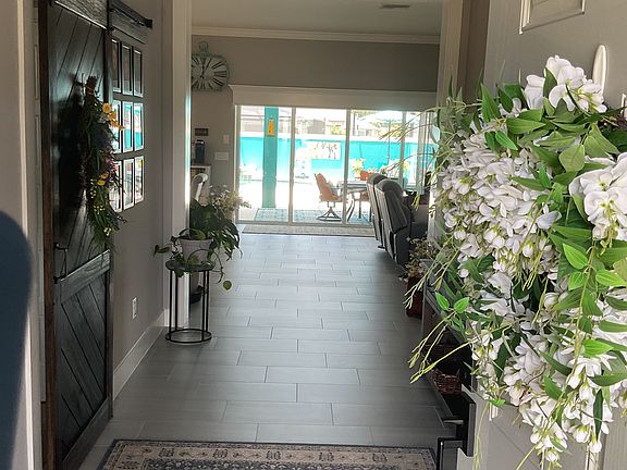 Walking in the front door with view straight back to the lanai and pool!