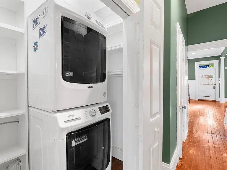 Hallway from Living Room & Kitchen with Pantry and Washer & Dryer