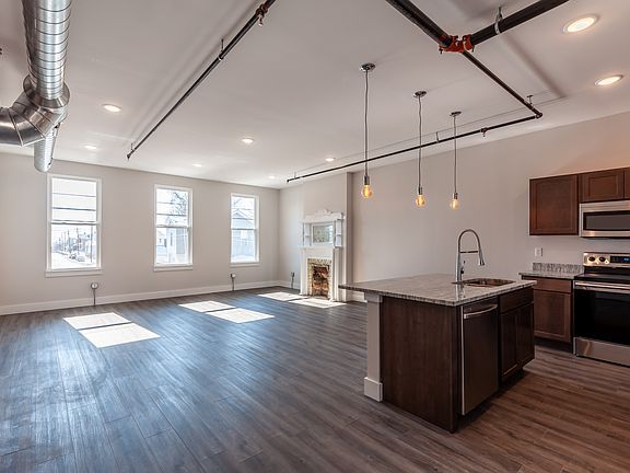 Fireplace in living room is inoperable but adds historic charm to this contemporary room.