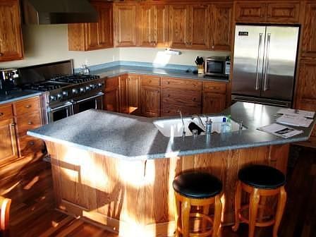 Sunny kitchen with oversized island is 