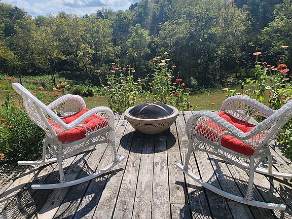 Backyard deck for watching wildlife or hummingbirds dancing around the flowers when in bloom. A firepit is enjoyed on those chilly nights.
