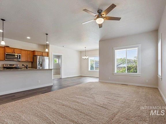 View of welcoming Great Room-Kitchen-Dining area from the carpeted Family Room