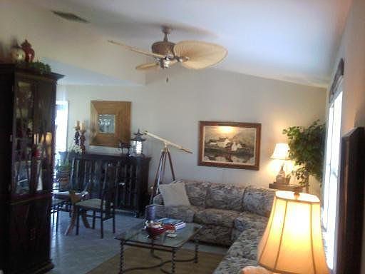Living Room with cathedral ceilings and beautiful ceiling fan.