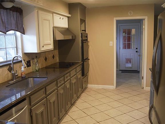 From the opposite side you can see through to the over-sized utility room and exit to the back yard