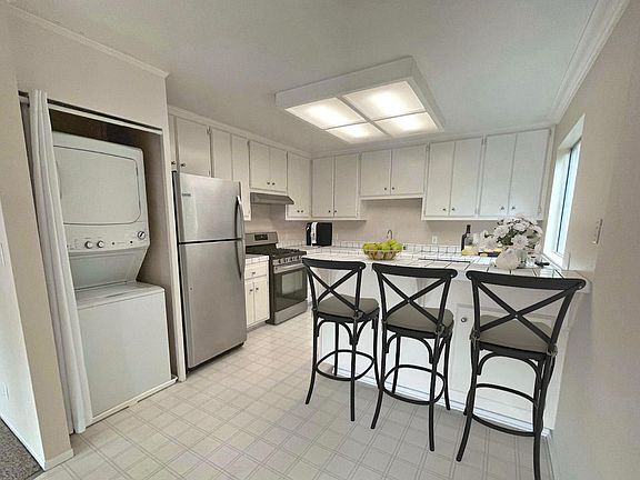 In-unit stakcable washer and dryer, stainless steel refrigerator, gas stove and dishwasher.