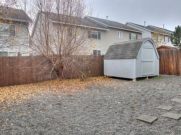 Fenced back yard with shed