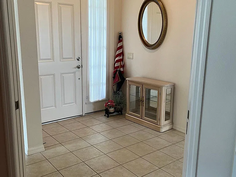 Foyer, has an American flag and umbrellas. Flag post on house.