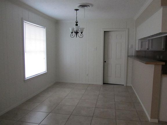 View of tiled breakfast area with kitchen on right