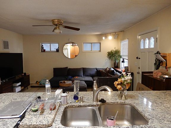 GREAT ROOM AND GRANITE KITCHEN COUNTERTOP WITH DOUBLE BOWL SINK AND GARBAGE DISPOSAL