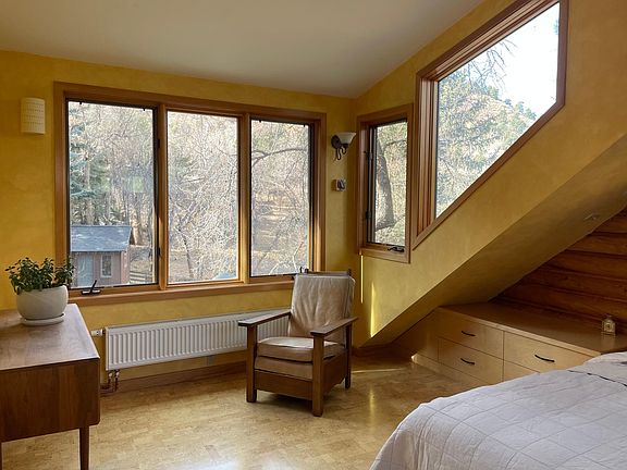 North-West facing bedroom with built in storage, sitting area and tons of natural light.