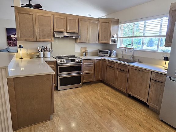 Organized kitchen with high-end equipment and new appliances including an induction range with double oven.