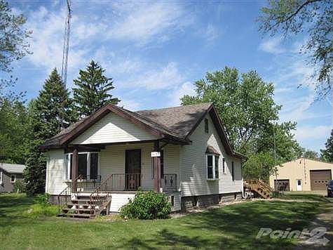 Open front porch and newer bay windows.