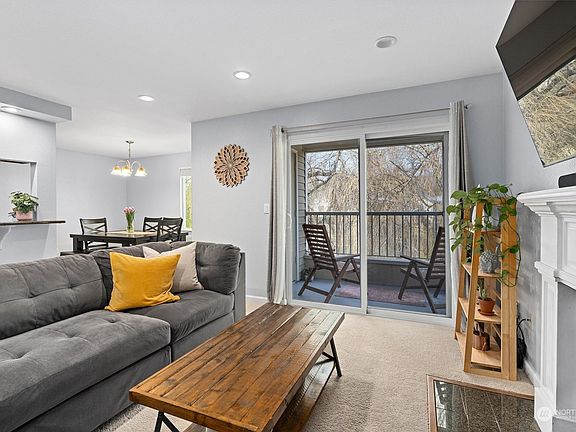 Cozy Living Room with Can Lighting and Wood Burning Fire>