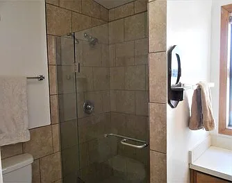 Upstairs bathroom with tile shower, large counter, six drawers, 4 shelves, optional towels, first aid, starter toiletries, etc.
