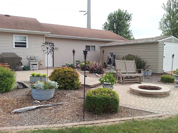 Beautiful fenced in back yard with fire pit, deck and patio's.