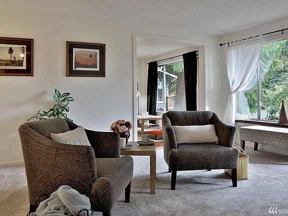 View of living room with entrance to the bonus room in the distance.  Another grand front window! 
