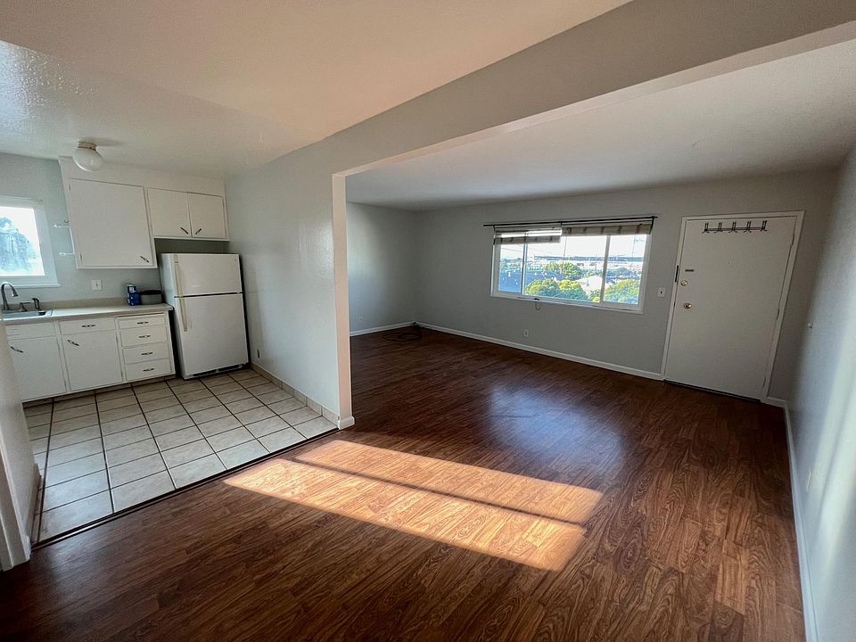 Full living room adjacent to full dining room. Huge window with unobstructed view of Mount Tam, Golden Gate Bridge, Bay Bridge and SF skyline.