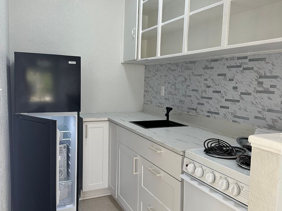 1929 bungalow upper cabinets mix with new all wood shaker style cabinets complete with a lazy Susan and stylish sink. Fridge is 1 year old and like new.