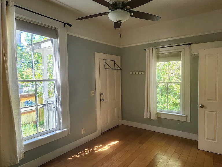 Bedroom with back entry, custom paint, period moldings.