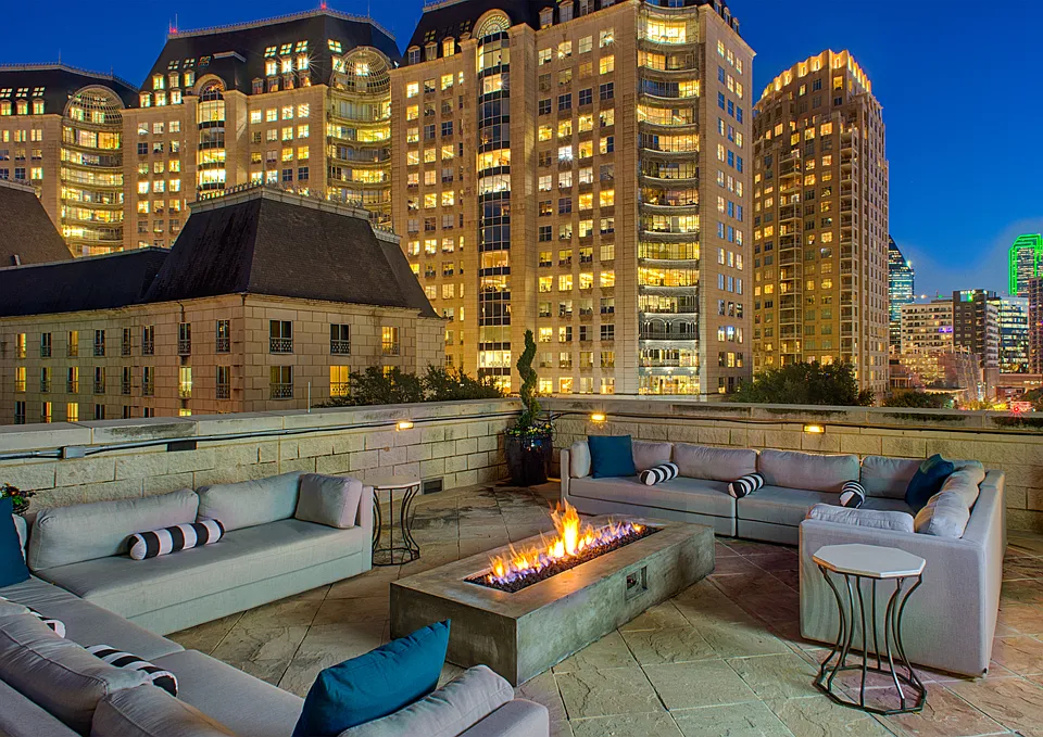 Luxury rooftop lounge with firepit and Uptown Dallas views