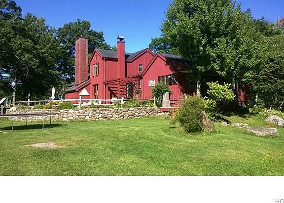 Rear view of home with large landscaped entertaining area