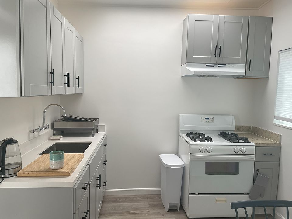 Newly-renovated, fully-stocked kitchen with kettle, coffee-maker, fridge, gas stove top, microwave.