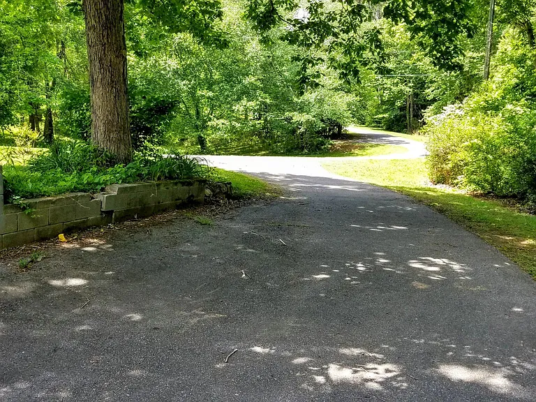 Looking from 21B apartment towards private Driveway and parking.
Landlord cuts grass.