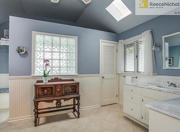 Master Bath Featuring Skylights, Tile Floor, Double Vanity and  Make Up Seating.